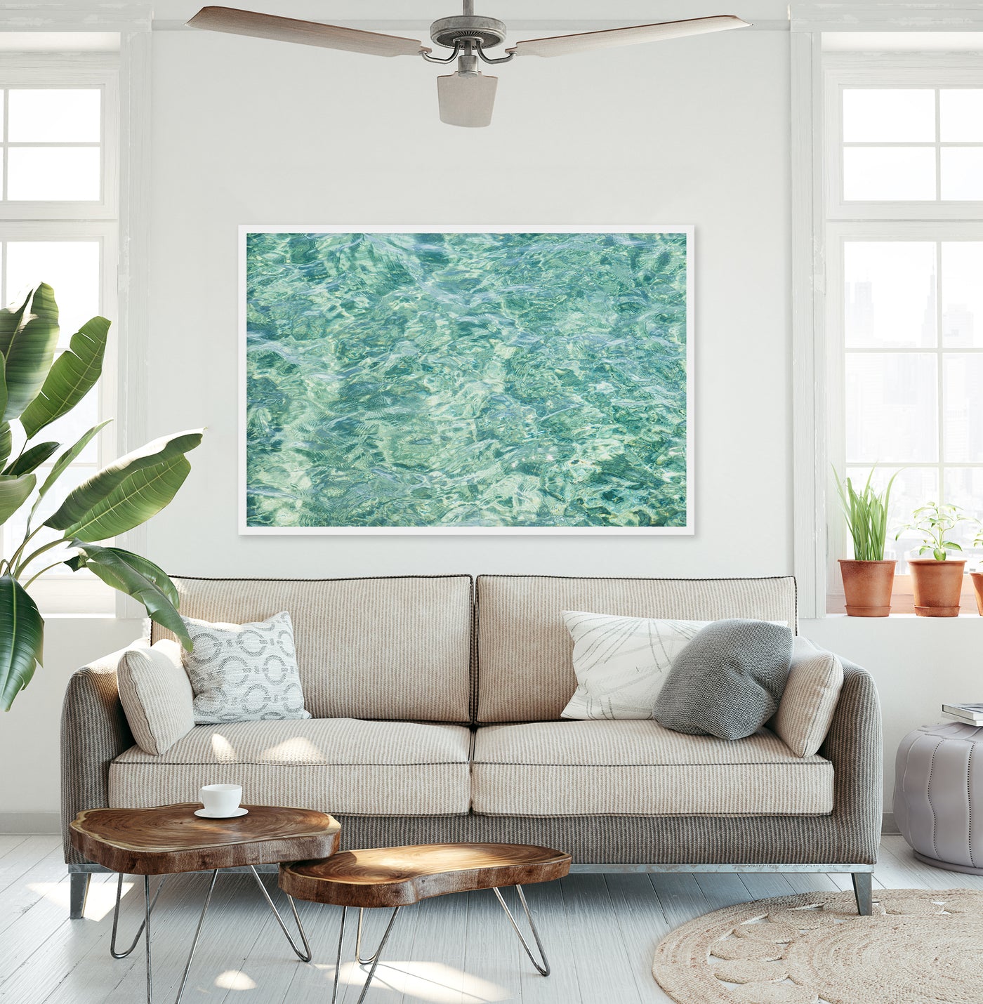 Large framed green abstract art print by Cattie Coyle Photography above couch in modern beach house living room