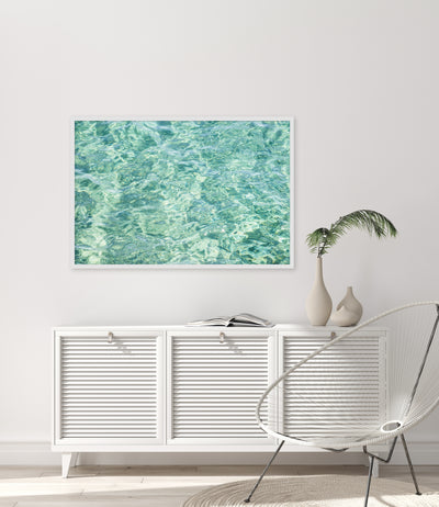 Framed green abstract art print by Cattie Coyle Photography above dresser in modern coastal living room