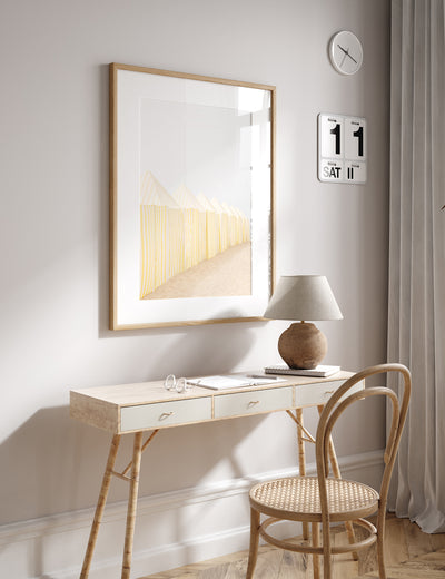Beach art by Cattie Coyle Photography framed above desk