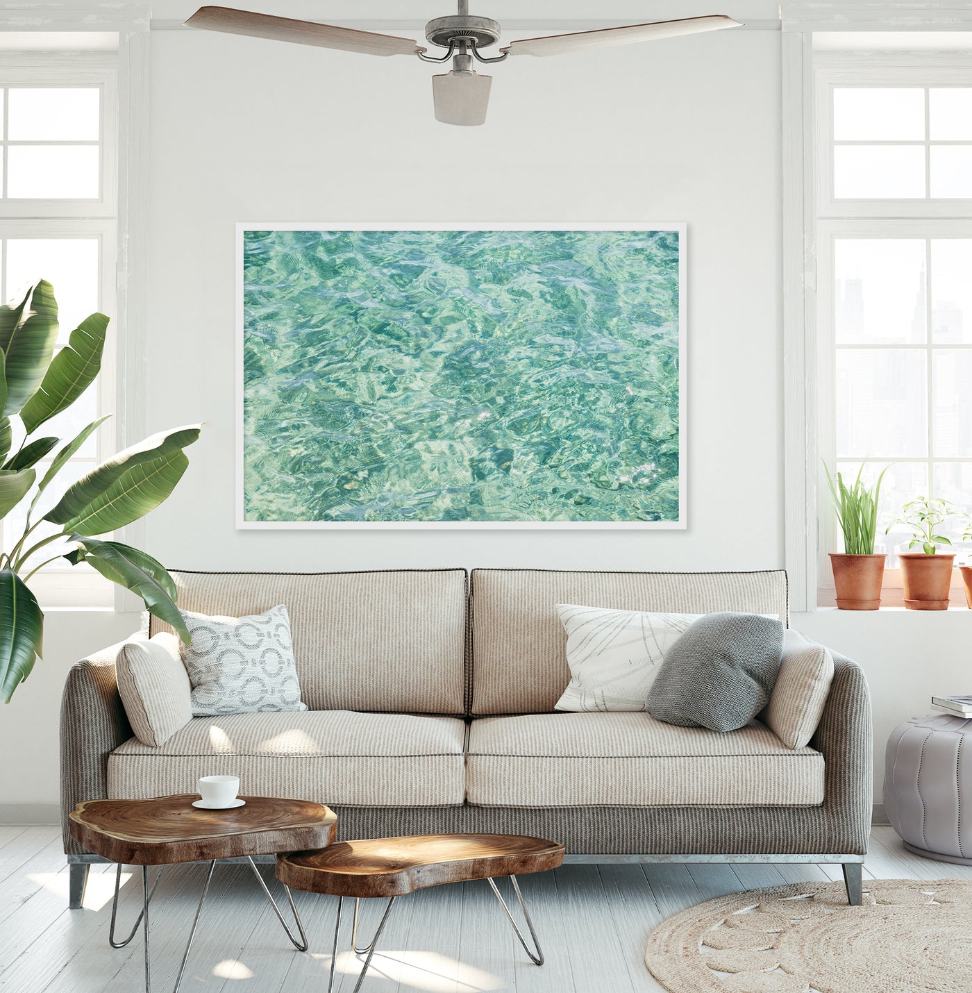 Large abstract coastal art print by Cattie Coyle Photography above couch in living room