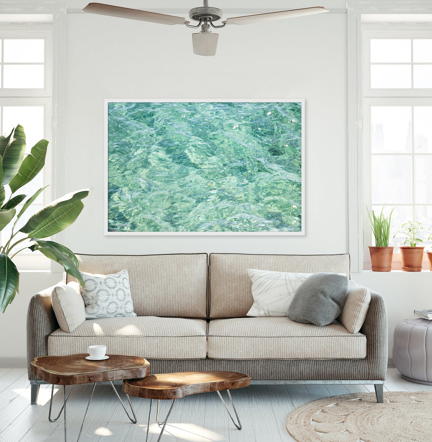 Large abstract green art print by Cattie Coyle Photography above couch in living room