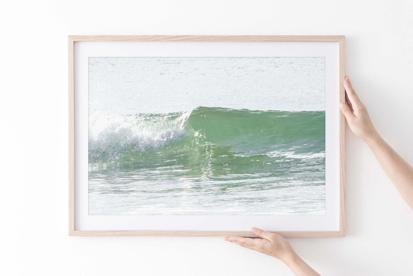Ocean wave wall art by Cattie Coyle Photography in natural wood frame