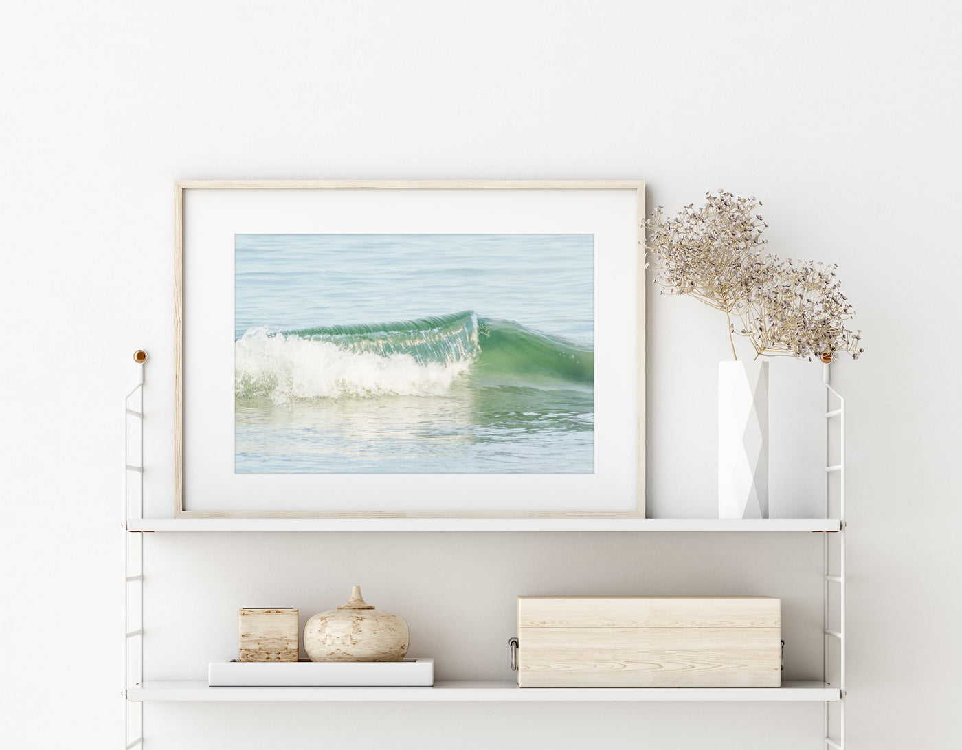 Ocean wave art print by Cattie Coyle Photography on string shelf