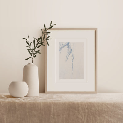 Sand Abstraction No 3 - Abstract art in blue and beige by Cattie Coyle Photography in frame on table